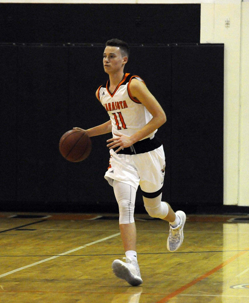 Sophomore Kaleb Fields brings the ball up the court for the Sailors.