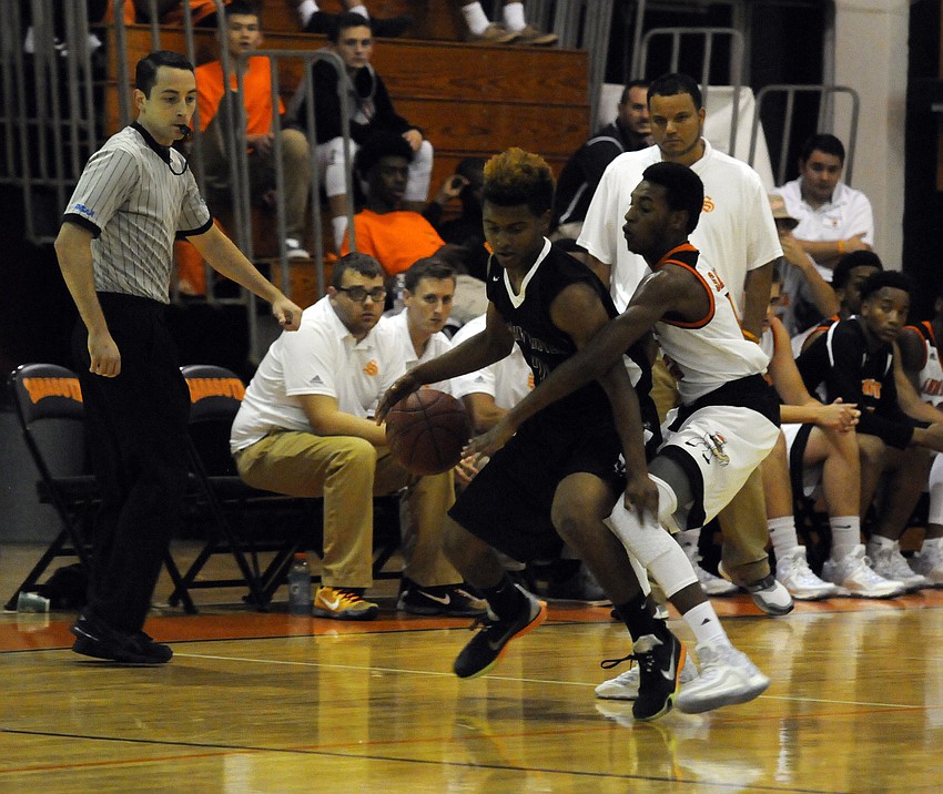 Braden River's Jordan Curtis attempts to maneuver around Sarasota's Adrian Langston.