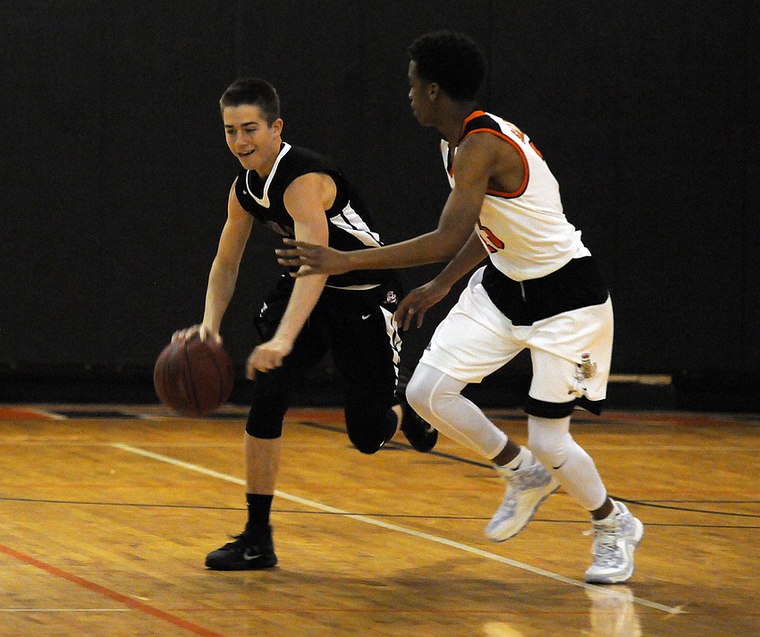 Braden River's Curtis Cobb attempts to bring the ball up the court against Sarasota's Joe Lawless.