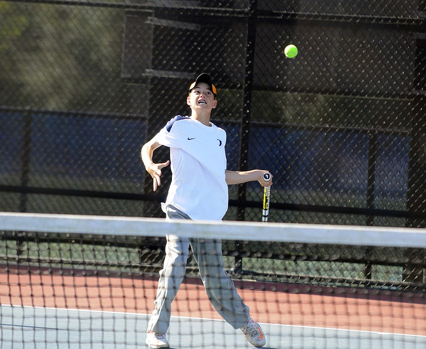 ODA’s Jake Krug returns a serve during his No. 4 singles match of the Class 1A-District 9 tournament March 30.