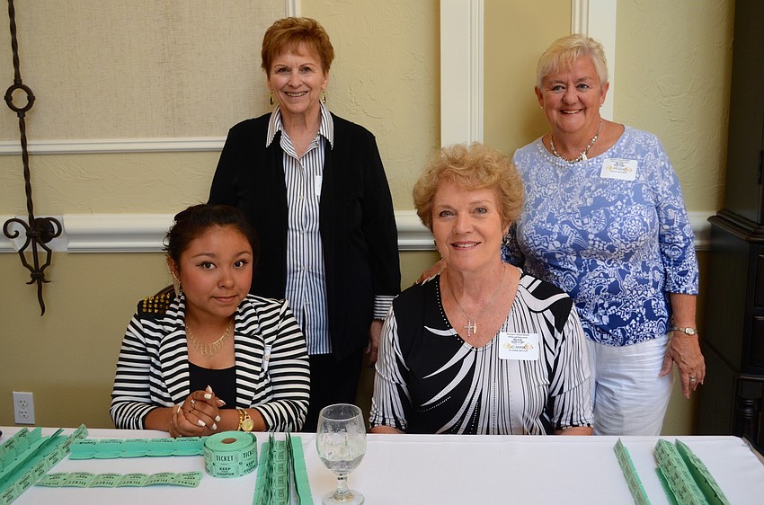 Carol Checovich, Peggy Butkier, Jo Anne Moyer and Mayra Lorenzana greet attendees at the door with smiles with raffle tickets.