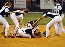 Third baseman SarahBeth Wengerd is mobbed by her teammates after hitting a 2-run walk-off double in the Class 7A-District 10 championship April 16.