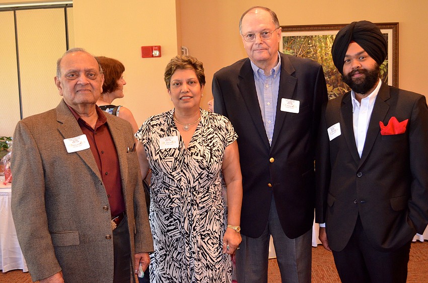 Kailash Jain and his wife and honoree Dr. Anila Jain, talk with family members Roger Frazee and Angad Dang before the luncheon.