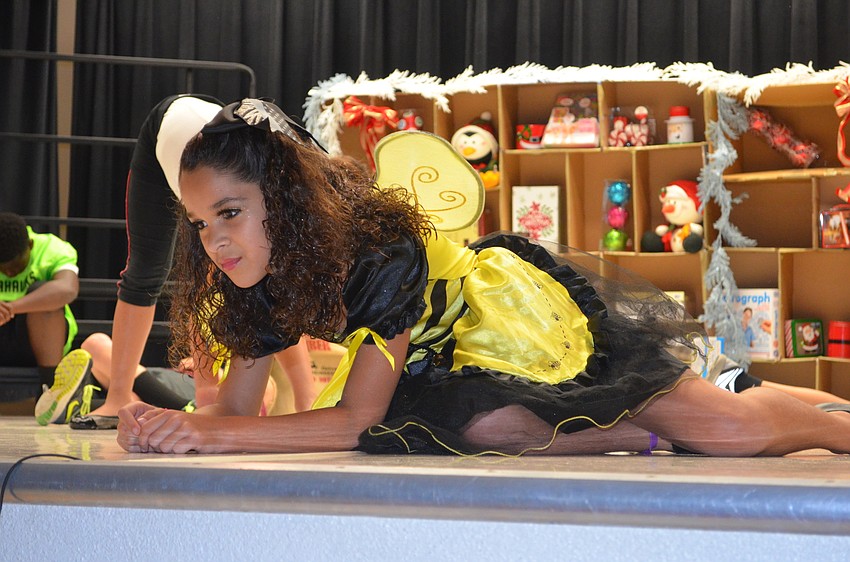 Brianna Duff is frozen while she plays a doll in a toy store.