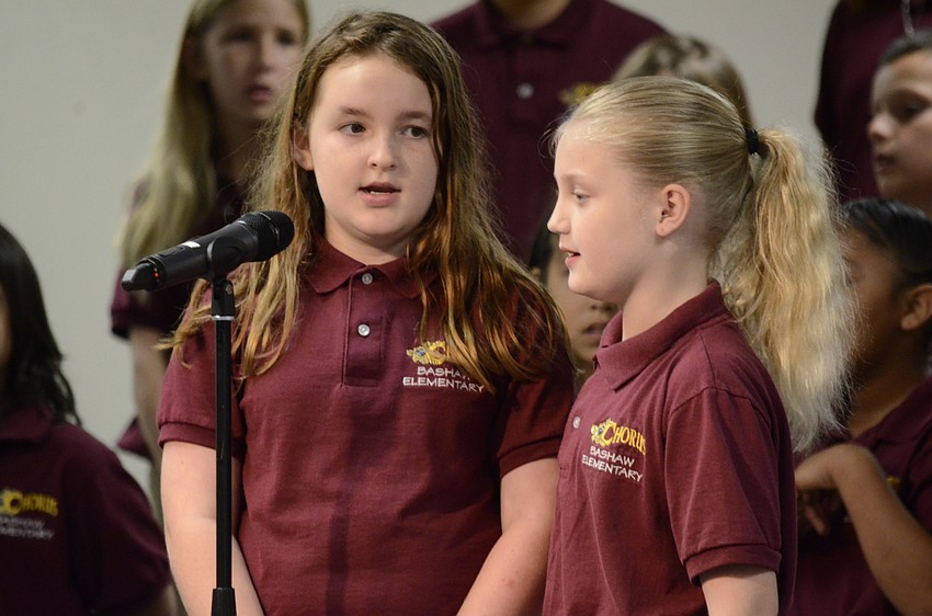 Sydney Brugger and Hailey Williams sing together.
