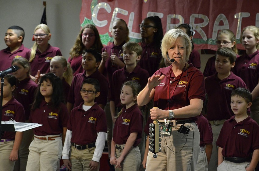 Music teacher Barbara Sullivan leads the whole school in singing Jingle Bells.