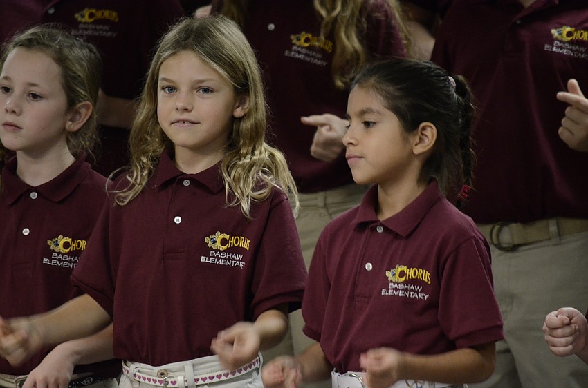 Emma Fowler and Valeria Marina snap their fingers to the music.