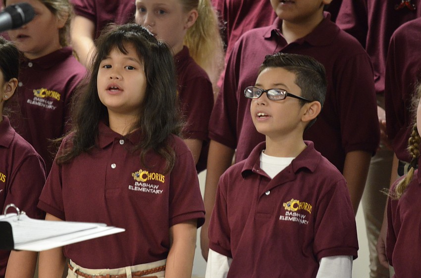 Allie Chan and Gerardo Gonzalez sing along with their chorusmates.