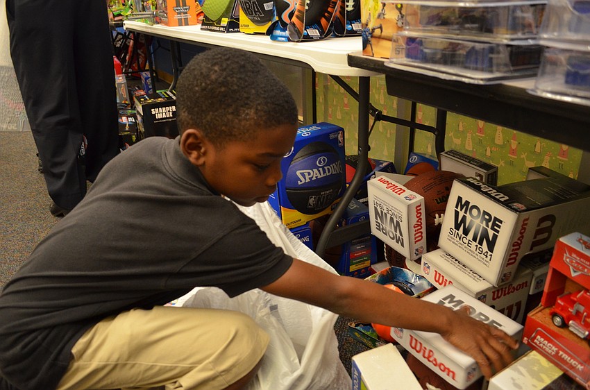 Jeremiel Platt decides which color football he wants to take home.