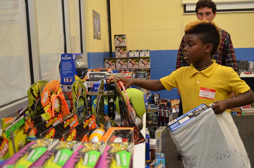 Kevontay Hugan ponders grabbing a Nerf basketball and hoop set as one of his gifts.