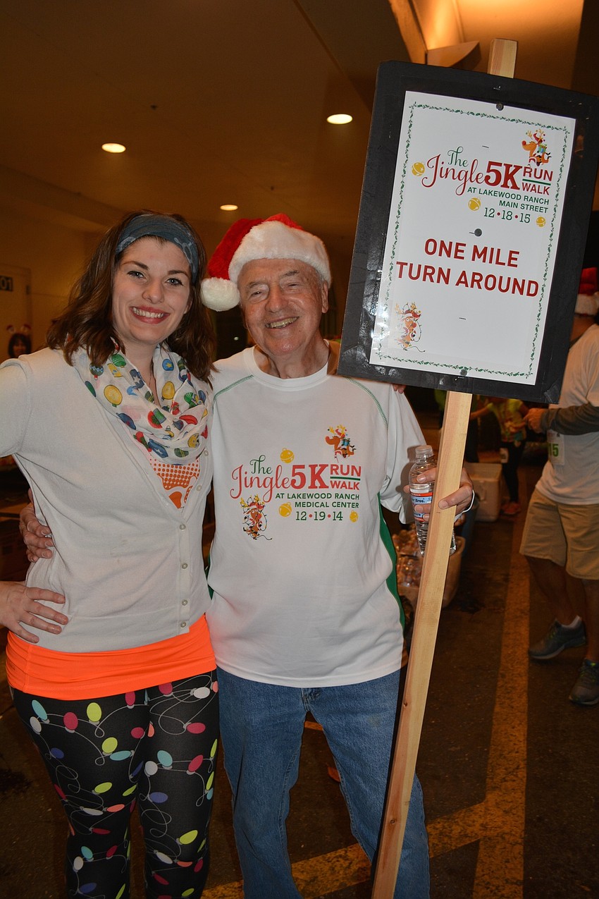 Volunteer Shelley Schreiber offers assistance to race director Doug Schiller.