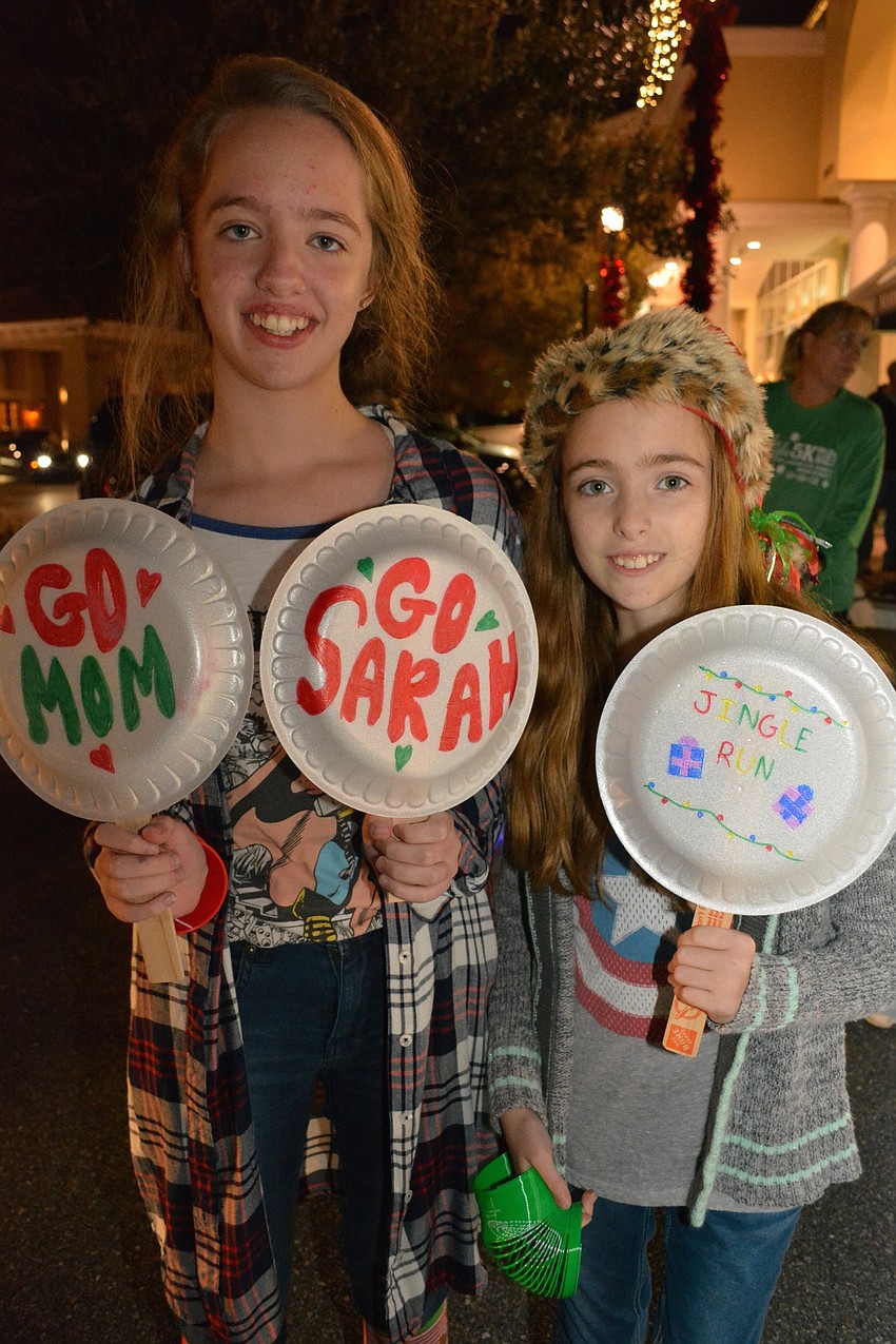 Olivia and Elizabeth Wilder, of Bradenton, cheer on their mom, Andrea.