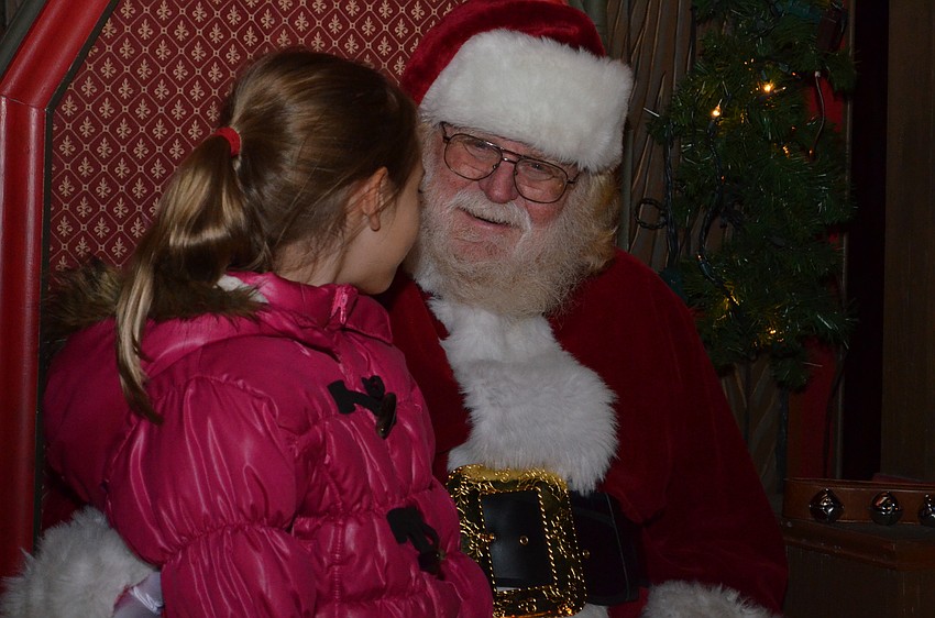 Camille Wright sits with Santa Claus.