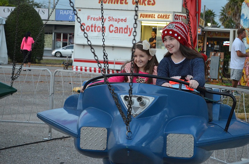 Charlotte Venture and Chloe Lawless take a spin on the airplane ride.