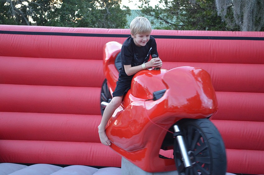 Riley Coyne does his best to stay on the motorcycle ride.
