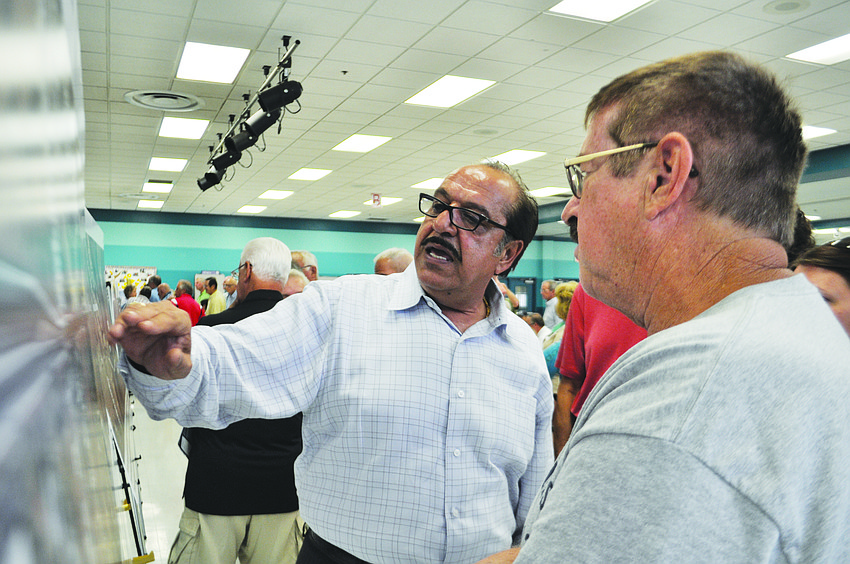 Manatee County employee Sia Mollanazar answers questions about the configuration of future Upper Manatee River Road during a public meeting at Haile Middle School.