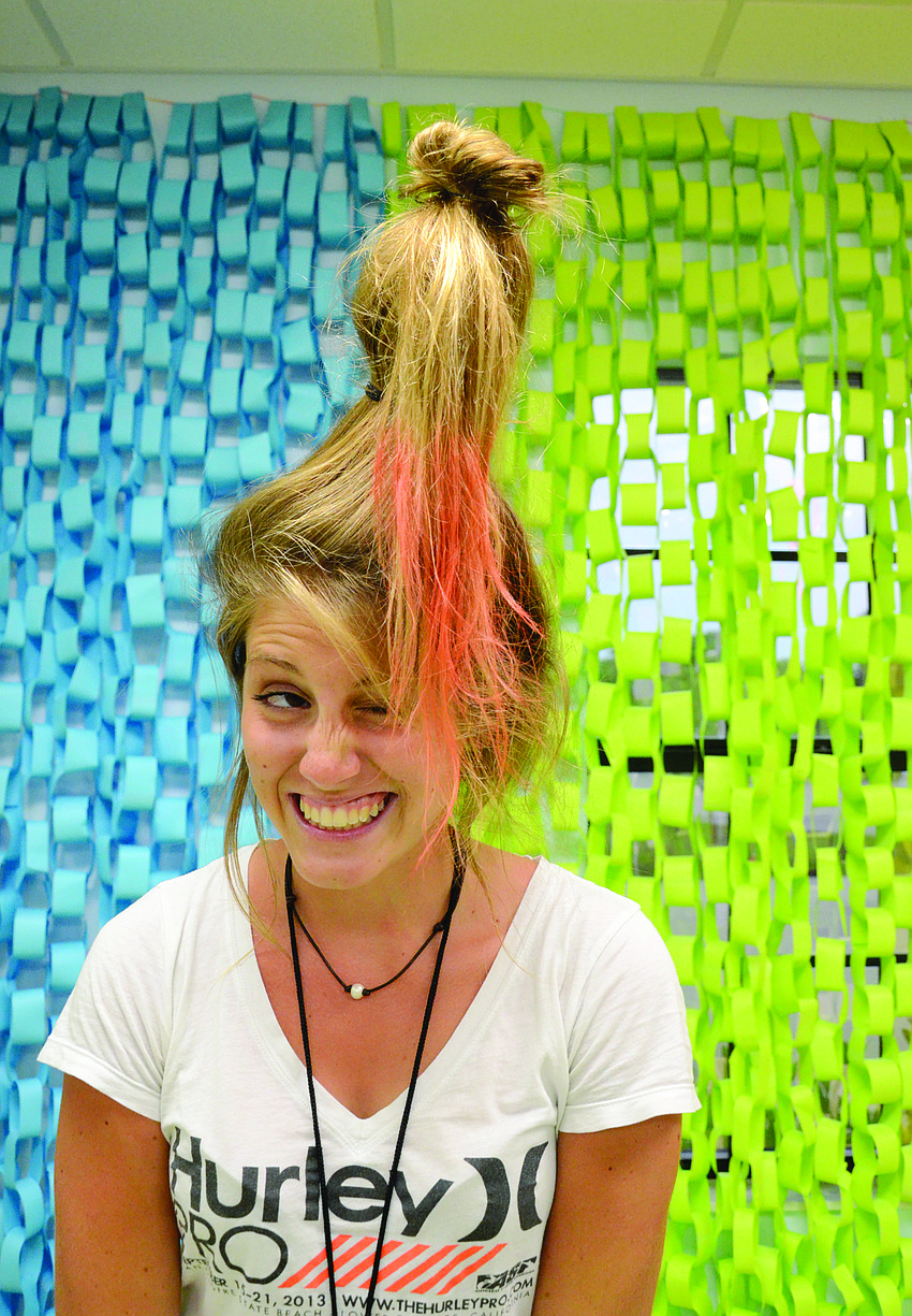 Volunteer Jenna Durst, 16, propped up her hair with a water bottle during River Life Church’s “Crazy Hair Day.