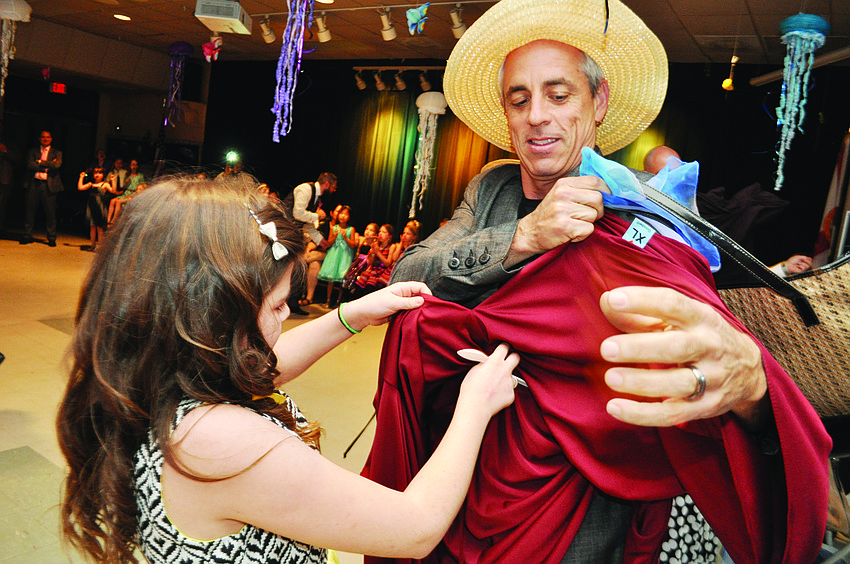Randy Bezet, right, competes in the dress-up-your-dad contest with his daughter, Emily, during Gene Witt Elementary’s father/daughter dance.