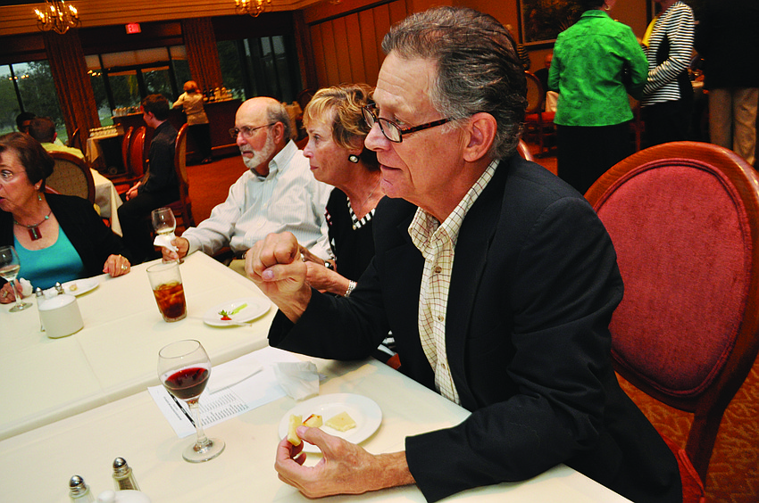 Malcolm Thornton chats with friends over appetizers, during the Art Association of Palm Aire Country Club’s artists’ reception.