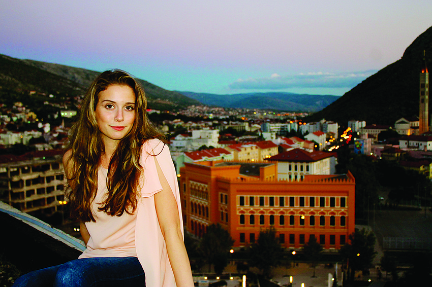 East County resident Alisha Erozer returned to school for her senior year at United World College of Mostar, in Mostar, Bosnia-Herzegovinia. This photo was taken on top of an old bank that was destroyed by war. The orange building in the background is Ero