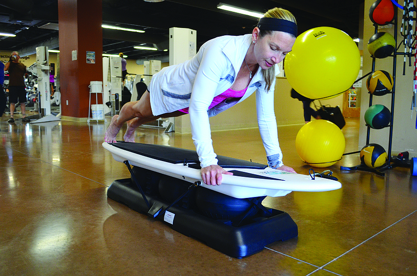 Carrie Wick demonstrates pushups and other exercises that would be part of her Surfset classes at the Lakewood Ranch YMCA.