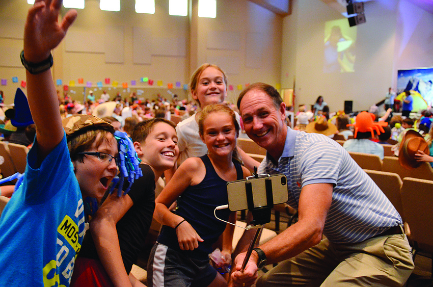 The Rev. Steve Price, right, takes a selfie with Harvest United Methodist Vacation Bible School attendees.