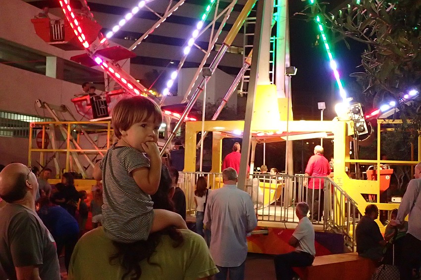 Phoenix Avery, perched on his dad's shoulders at the celebration