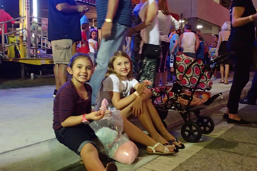 (right to left) Erin Noe and Jersey Baldini take a break for some cotton candy.