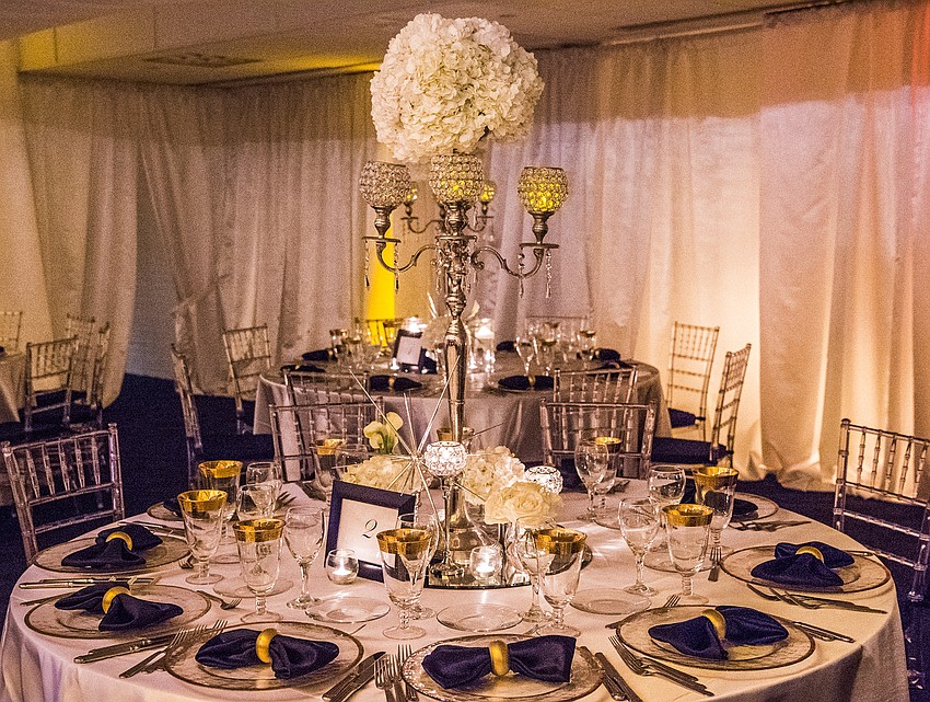 Organization & Design: Roger Capote.
Catering and table decor: Michael's On East
Florals by Flowers by Fudgie. 
Draping and lighting: Affairs in the Air, Inc.