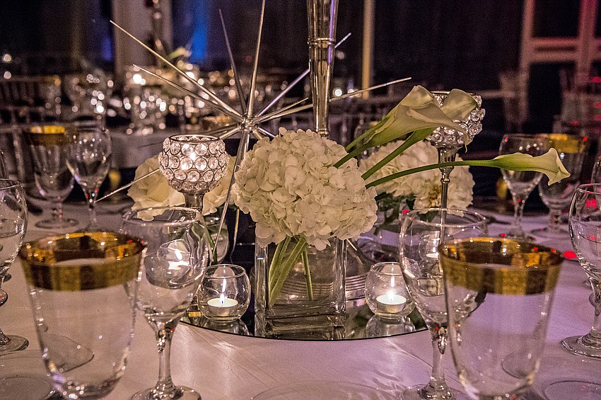 Catering and table decor: Michael's On East
Organization & Design: Roger Capote.
Florals by Flowers by Fudgie. 
Draping and lighting: Affairs in the Air, Inc.