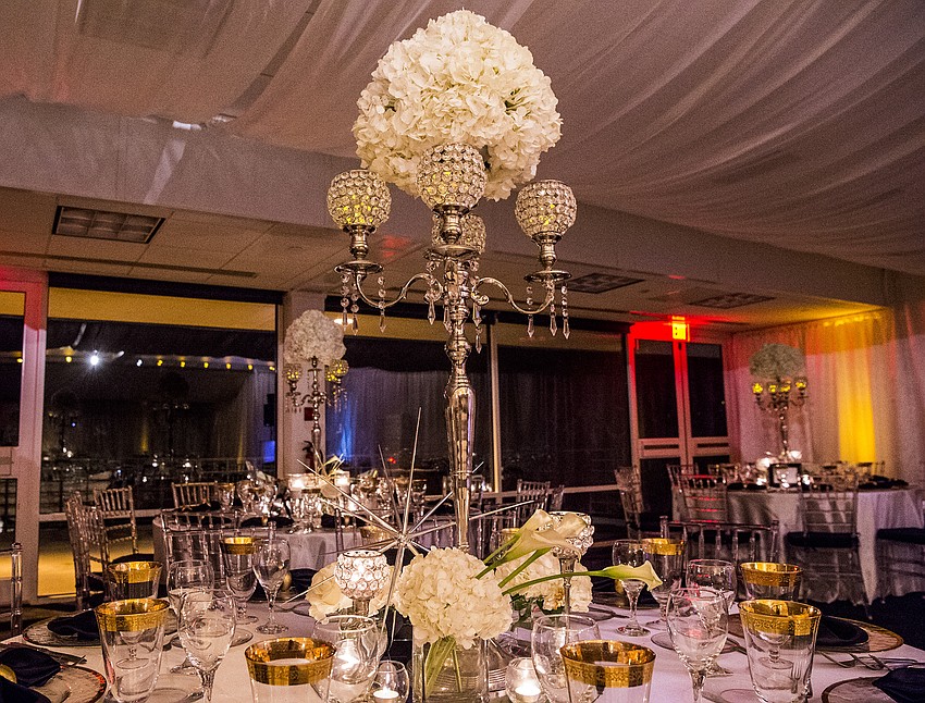 Catering and table decor: Michael's On East
Organization & Design: Roger Capote.
Florals by Flowers by Fudgie. 
Draping and lighting: Affairs in the Air, Inc.