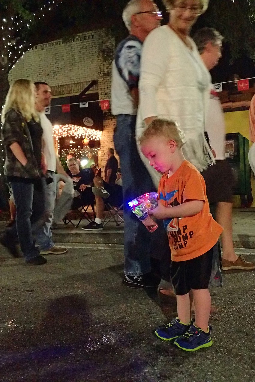 Connor Pippen-Craven is fascinated by his bubble gun, not so much by the festivities.