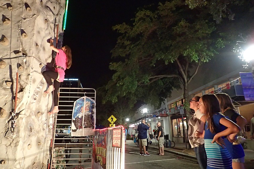 Amber Taylor, Lindsay Page and Jocelyn Freed watch as Julie Freed tries to win $100 on the hard climb.