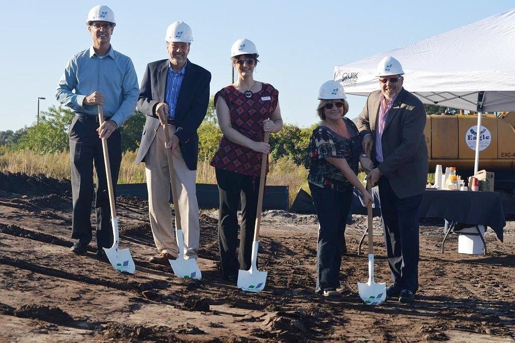 Jeff Burkee, senior vice president Bank of Commerce, Bob Simon, president of development for SMR, Laura Adcock, WBRC Architects, and Crawford Construction owners Utahna Smith and Jeff Smith break ground.