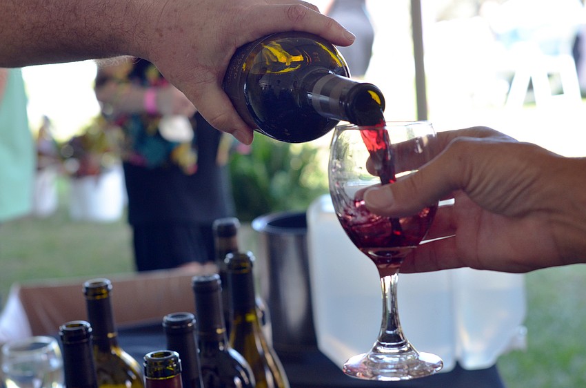A guest samples a Round Pound Estate cabernet.