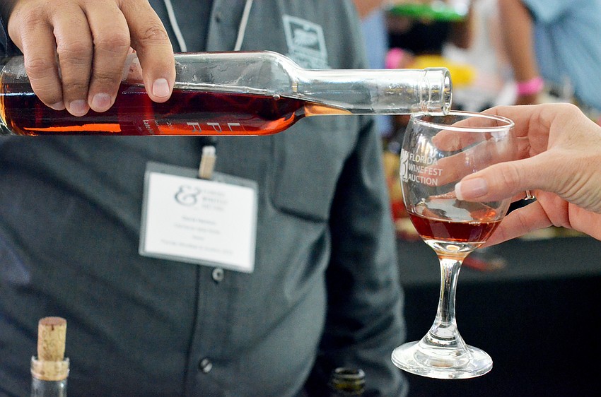 A guest samples a late harvest pinot from Carneros Della Notte.