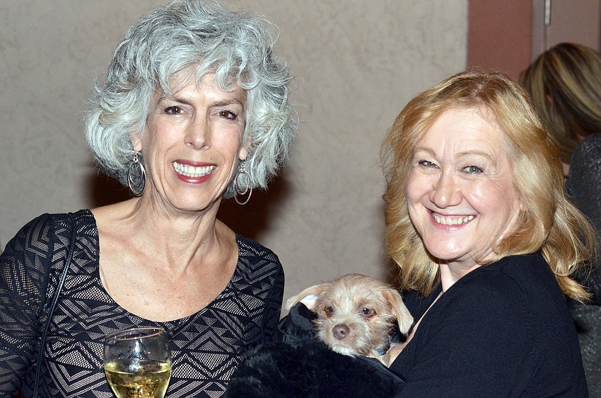 Ava Whaley and Carole Frank with Mr. Darcy, a Wheaton Terrier mix she adopted at the event.