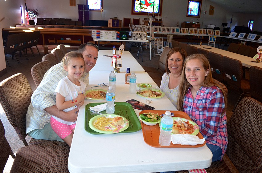 Addison Crutchfield and her father, Phillip, enjoy dinner with friends Jen Lonero and Sarah Farmer.