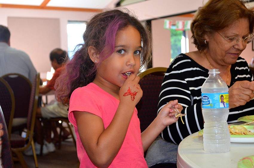 Iyleigh Hayes samples a piece of spaghetti before diving in.
