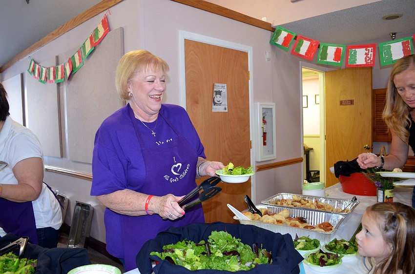 Debbie Hendershot serves up salad and smiles.