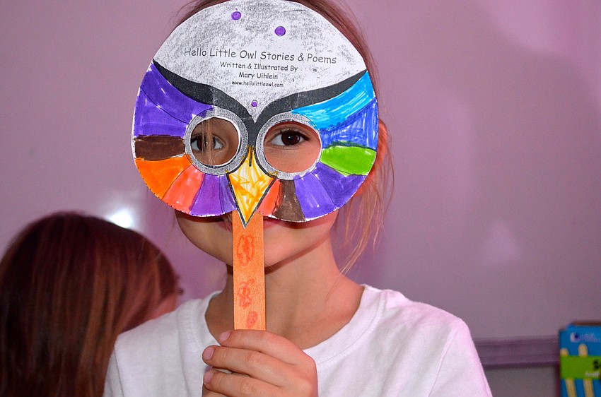 Six-year-old Julia Mulligan shows off her new mask.