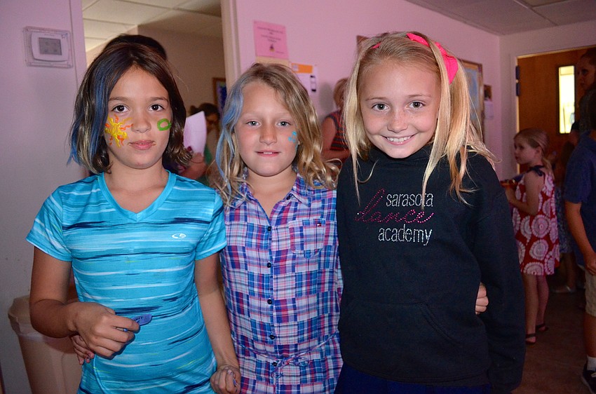 Isabella Vahn, Charlotte Clark and Bella Sosso show off their decorated hair and faces.