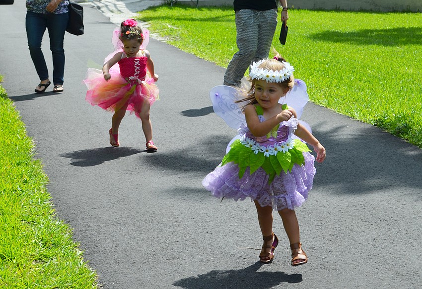 Abbi Peters and Alexa Freck flutter down the path at Historic Spanish Point for the Fairy House Festival.