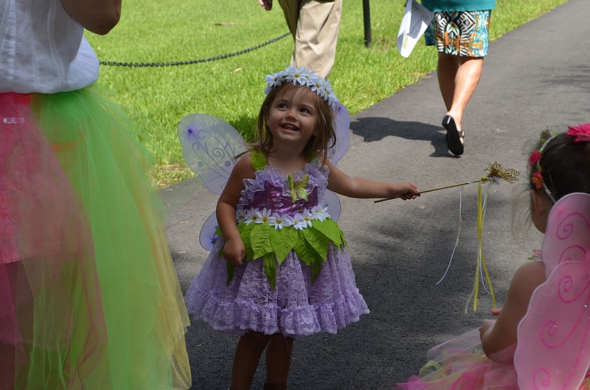 Abbi Peters accepts a fairy wand from the Fairy of the Daisies.