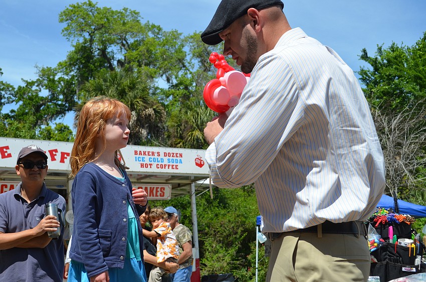 Lucy Gleim is fitted for her balloon crown by Brad Mock.