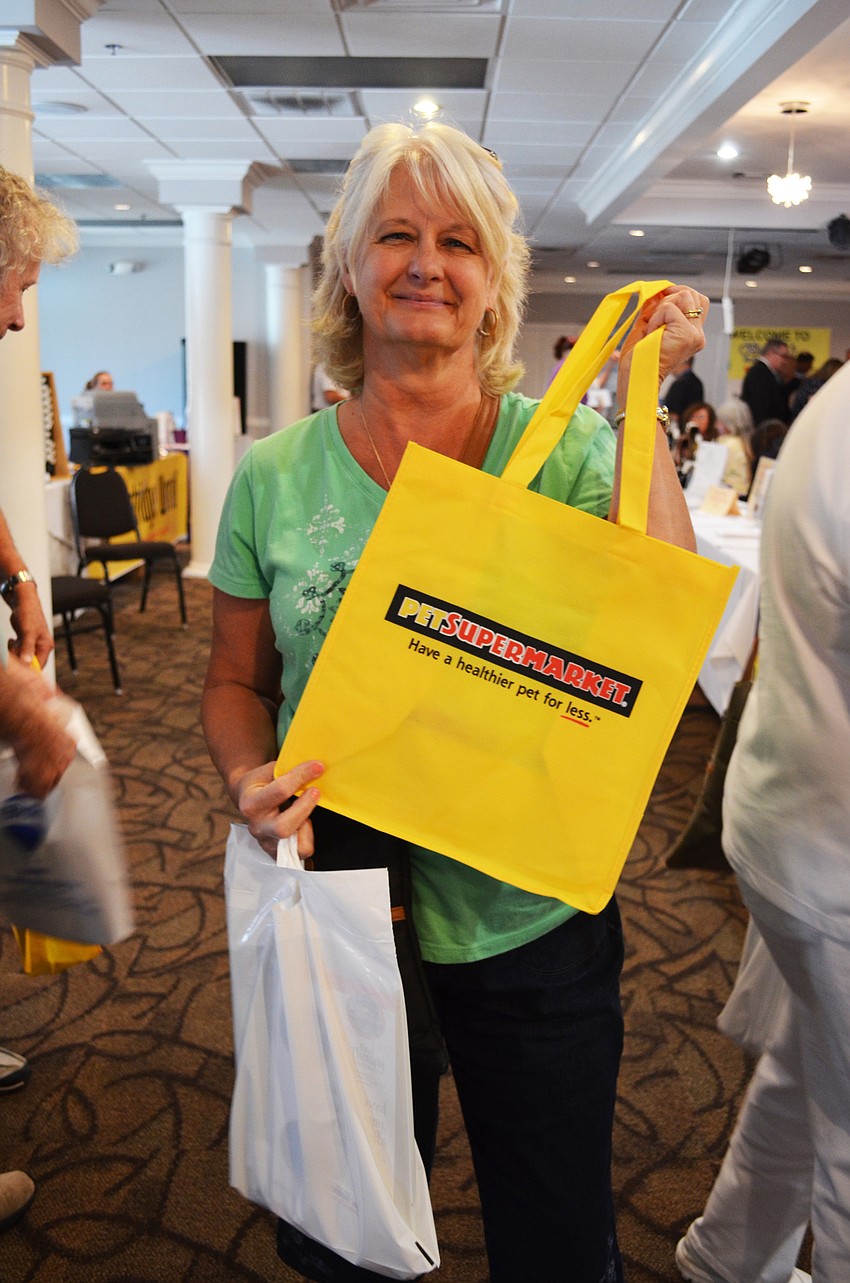 BarbSchust-Resident Barb Schust shows off merchandise from local businesses.