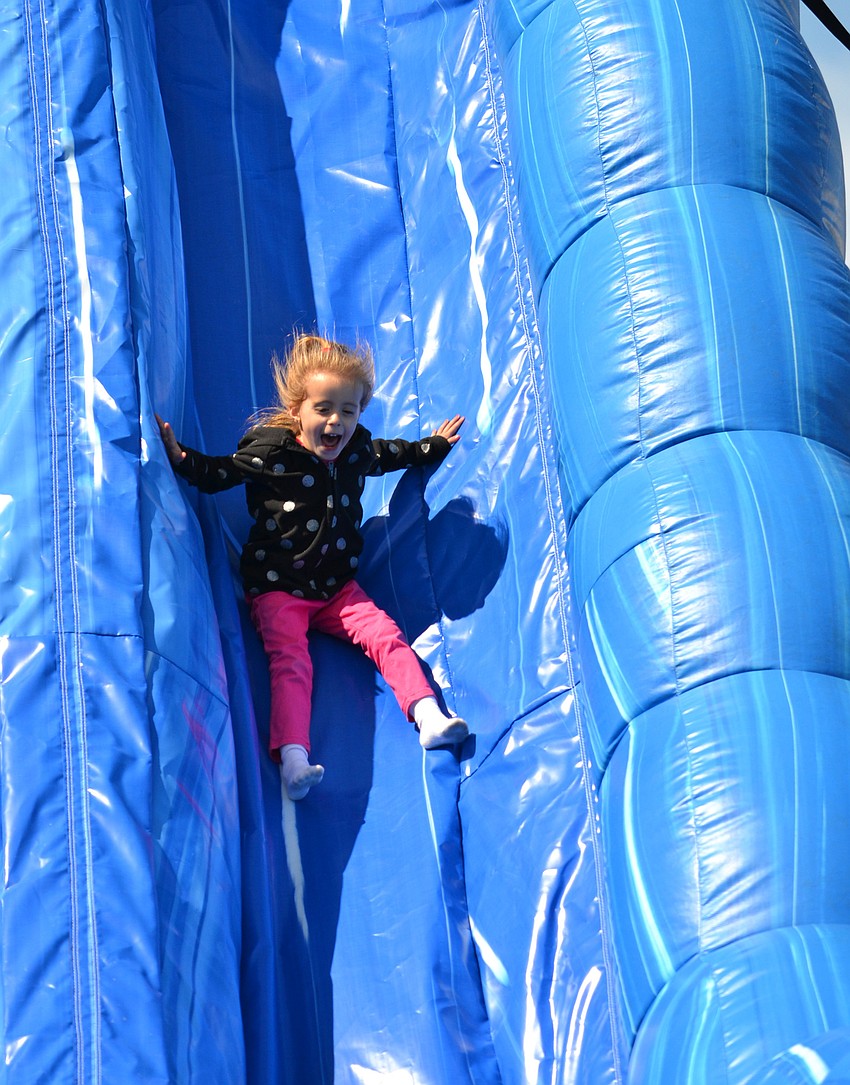 Aubrey Sponable slides down the inflatable slide.