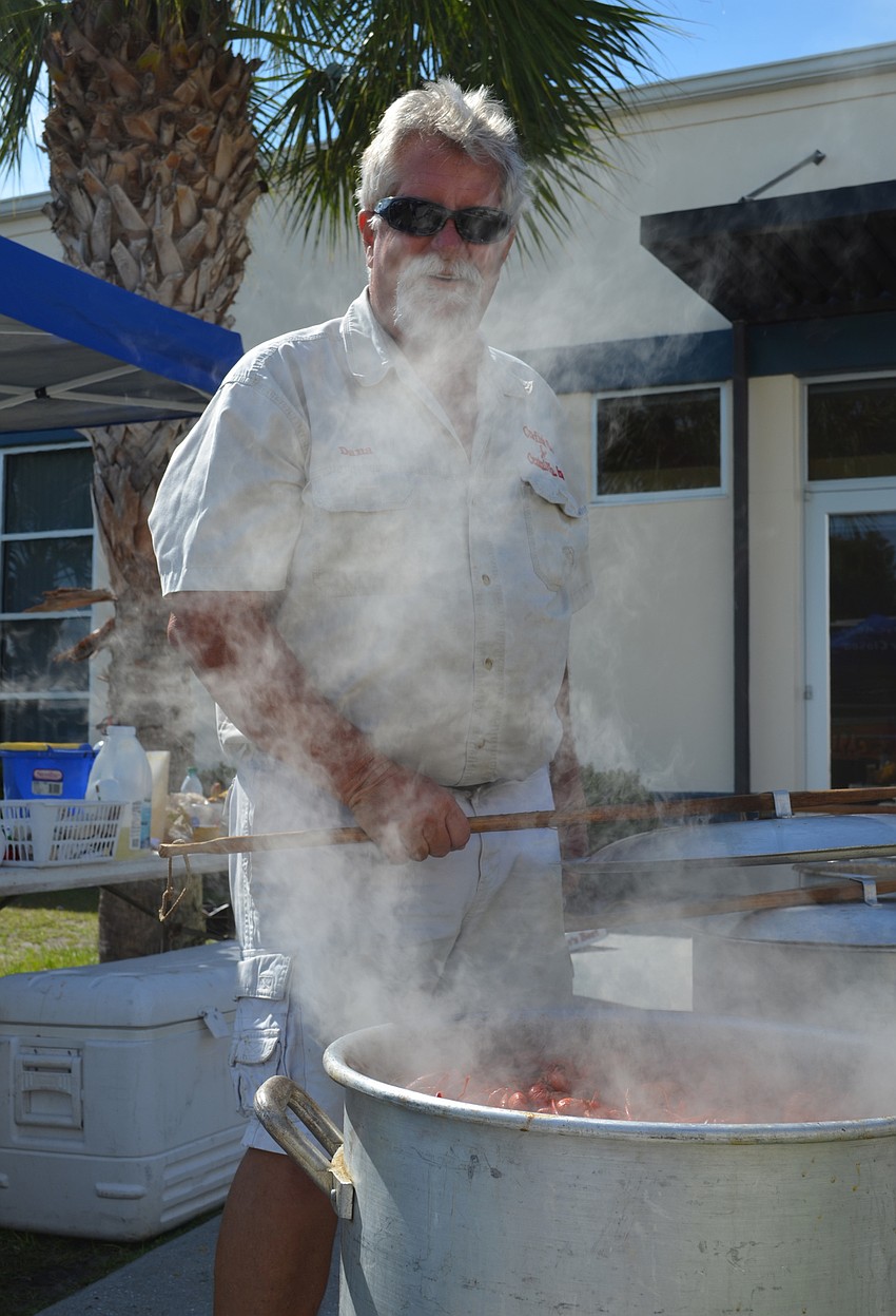 Dana Aikin prepares the crawfish in a boiling pot.