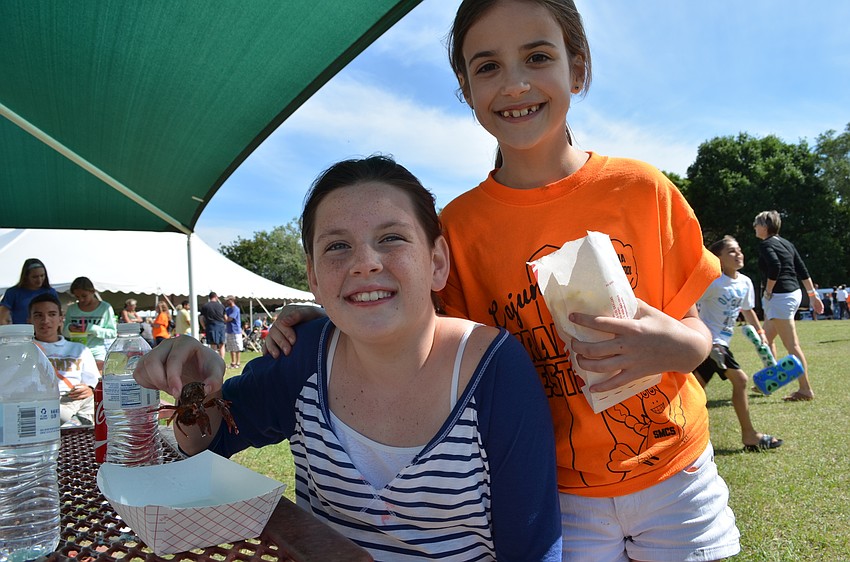 Mallory Lumpkin and Bianca Smith with a live crawfish they named Missy.