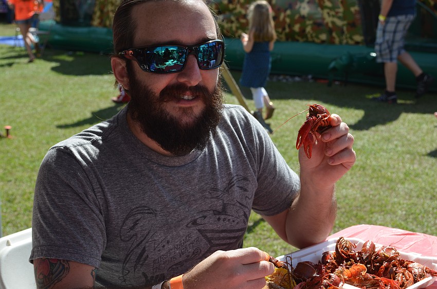 Ross Pitts picks out a crawfish from his meal.